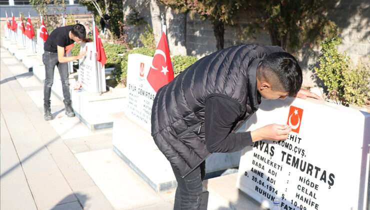 Niğde’de 2 genç, şehitlikteki Türk bayraklarını yeniledi